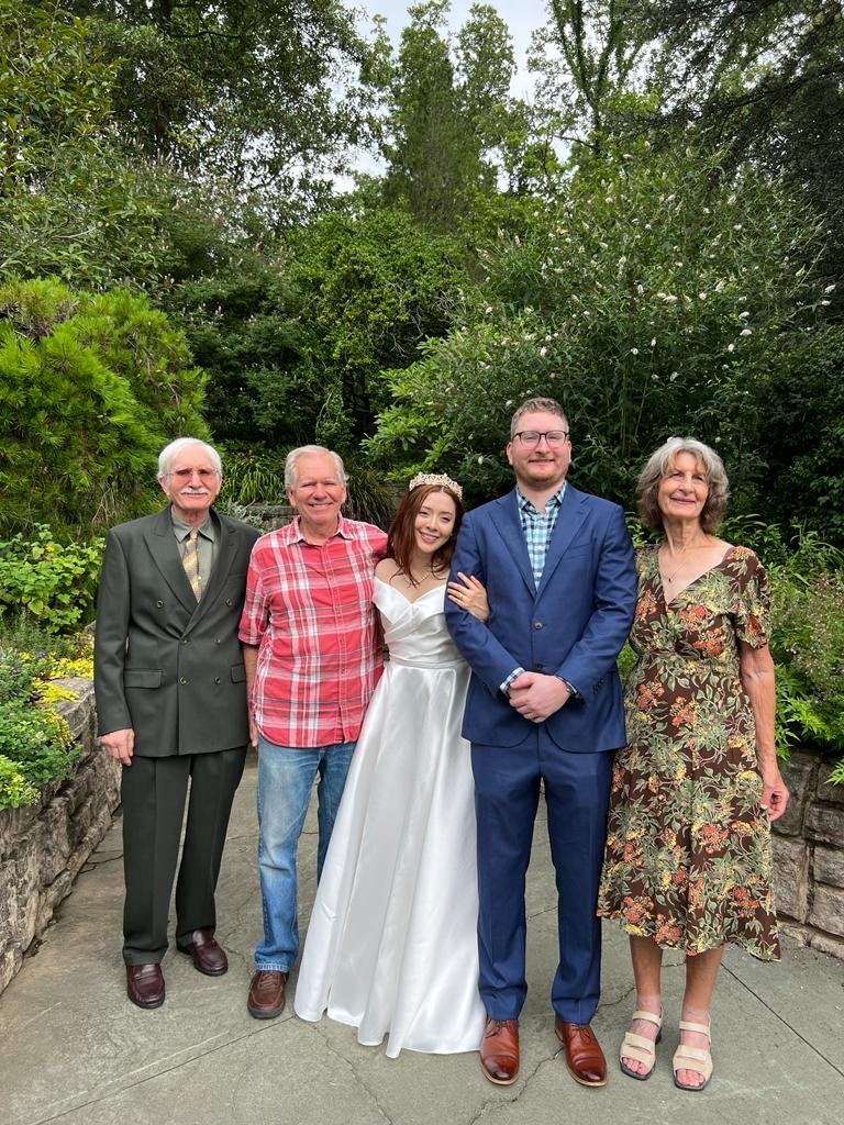 Interfaith wedding ceremony with couple and family